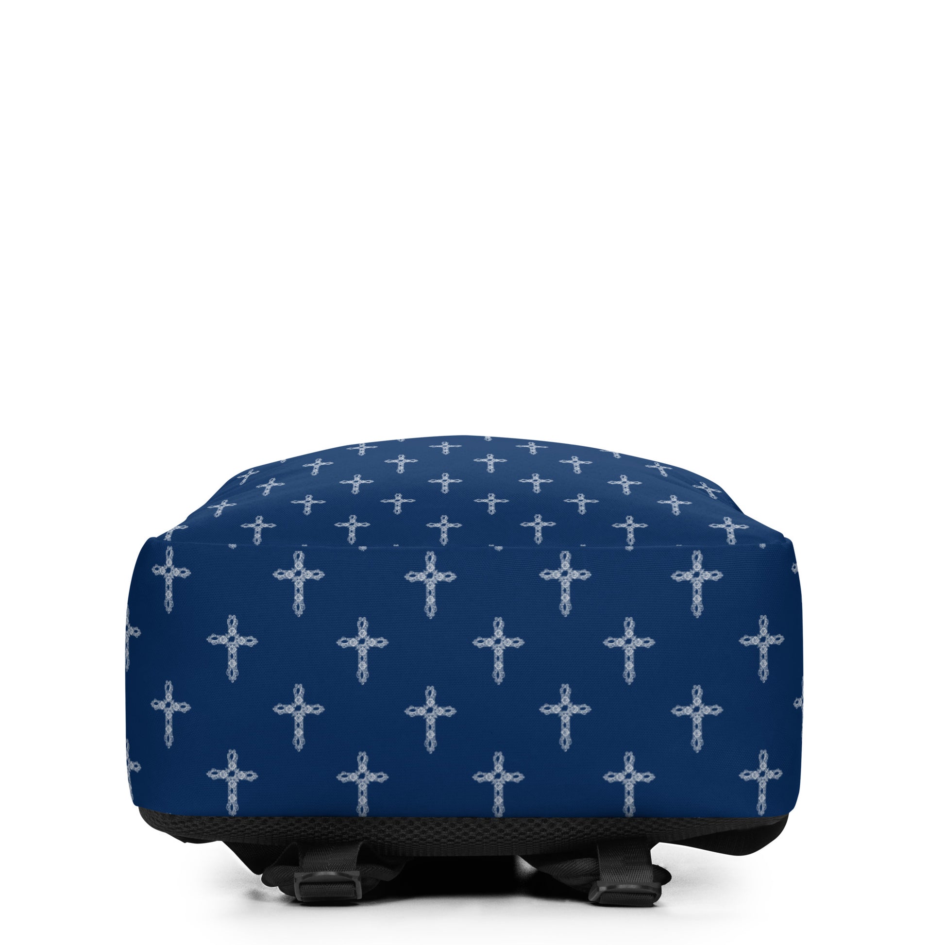 Bottom view of navy blue backpack with a white cross print on a white background