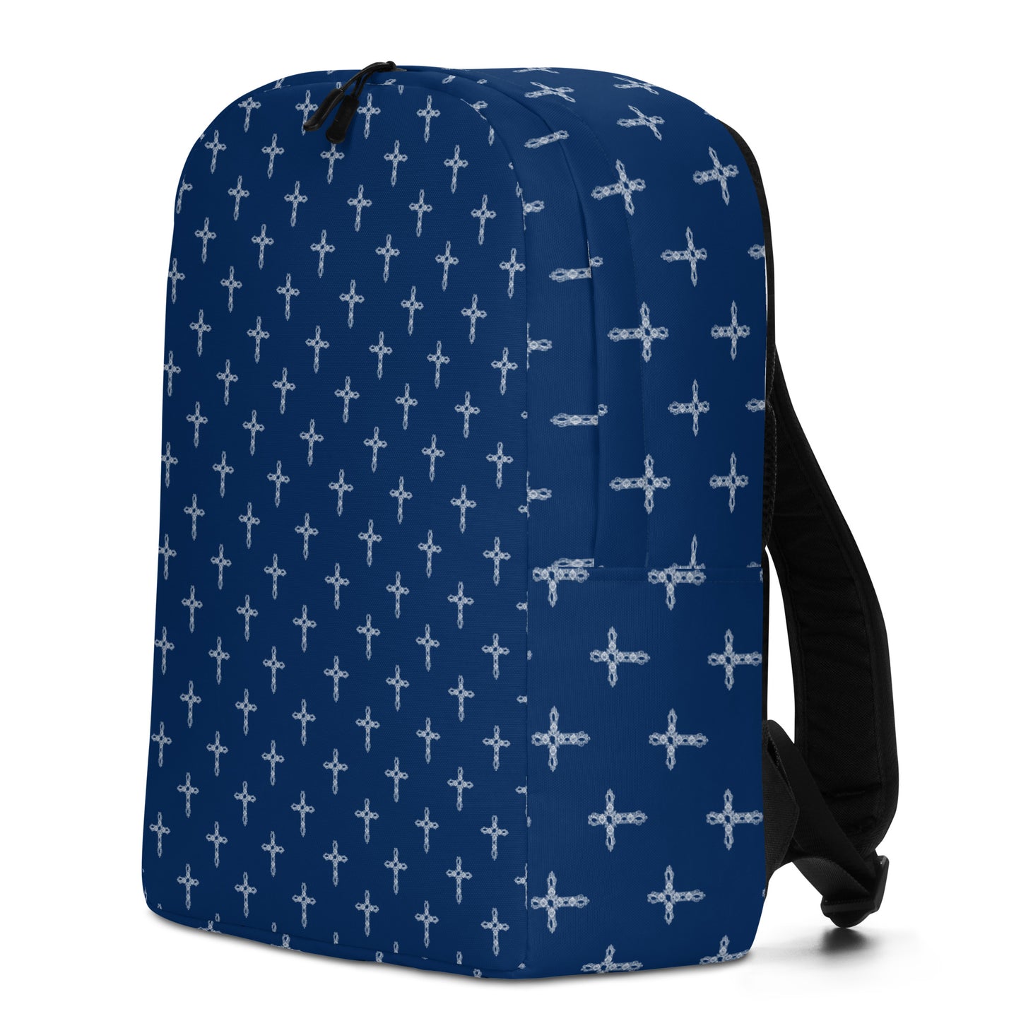 Side and front view of navy backpack with black straps. Backpack has a print of white ornate crosses all over it.