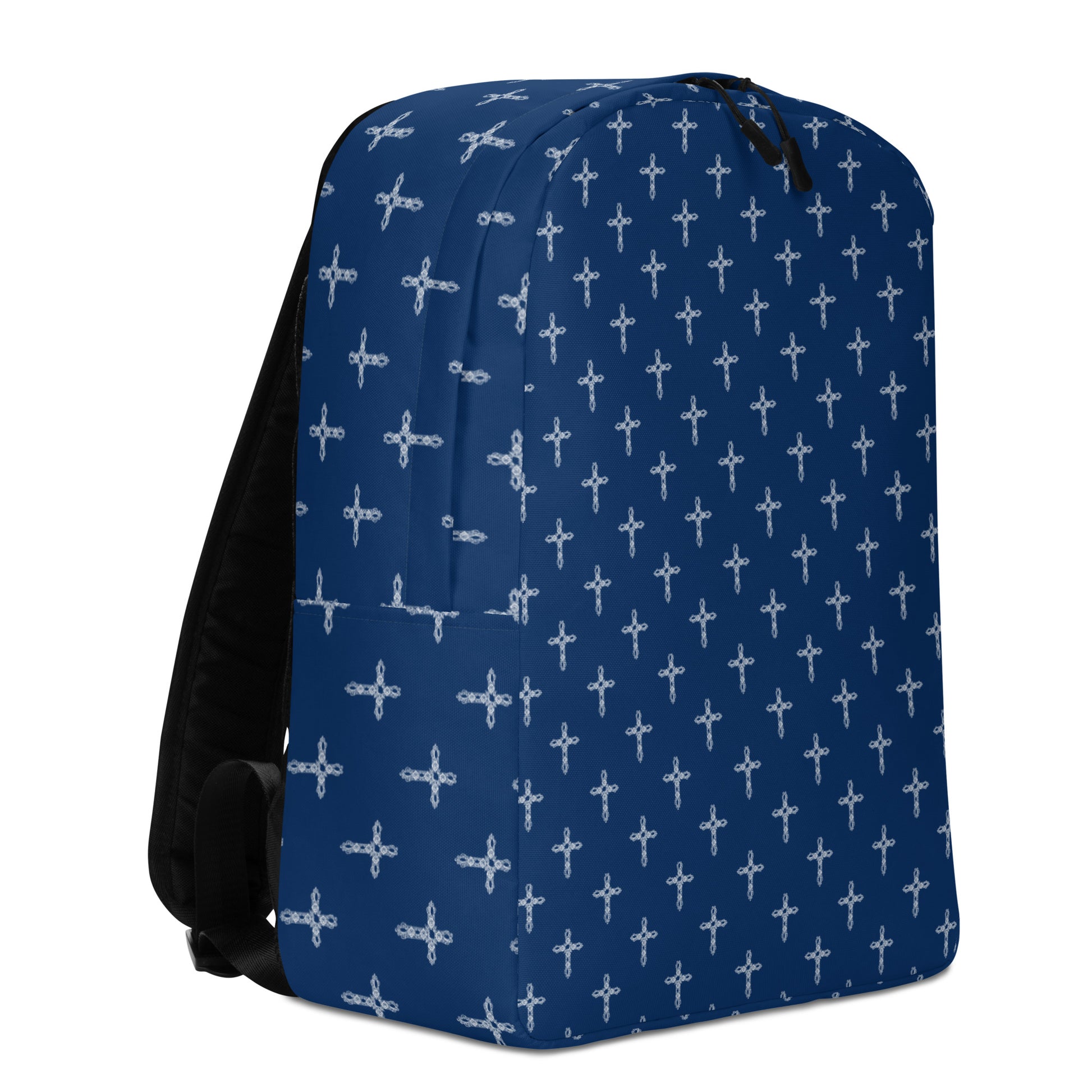 Navy backpack with black straps and ornate white crosses all over it on plain white background.