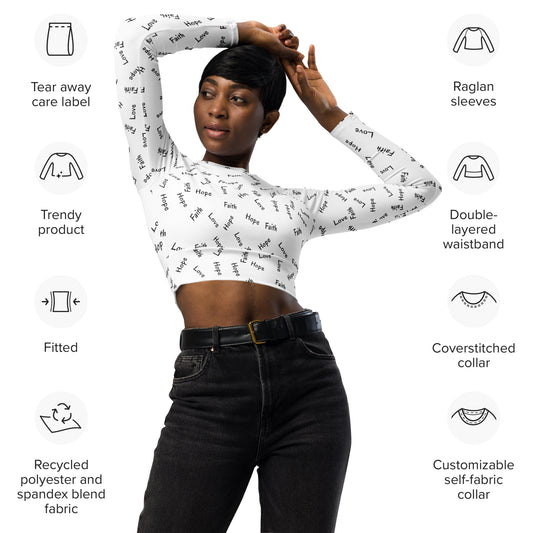 Woman with arms raised over and resting on top of her head, wearing belted black jeans and a white long-sleeved crop top that is printed in black with the words Faith Hope Love all over it, and around the person, on a white background are graphics with information about all the features of the shirt.