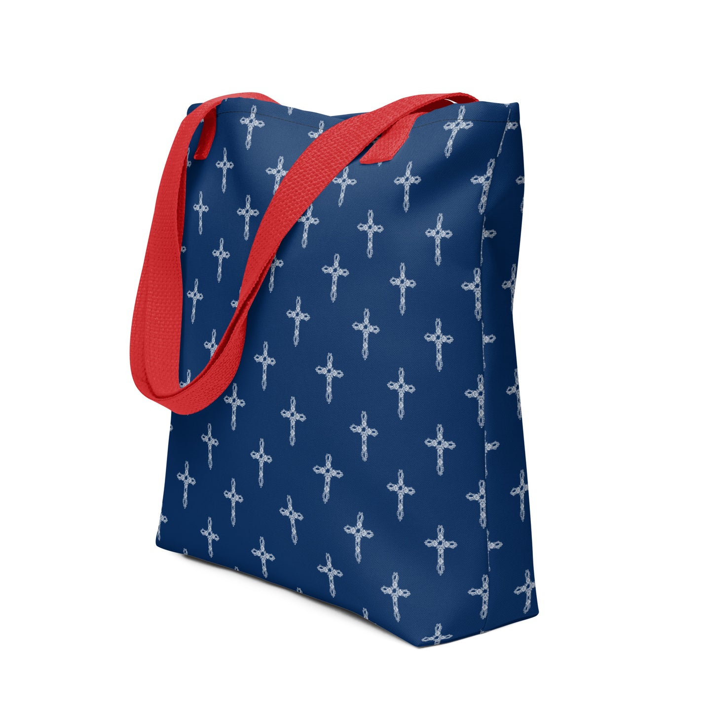 Navy blue purse with red handles. There is a pattern of white crosses on the tote bag or purse.