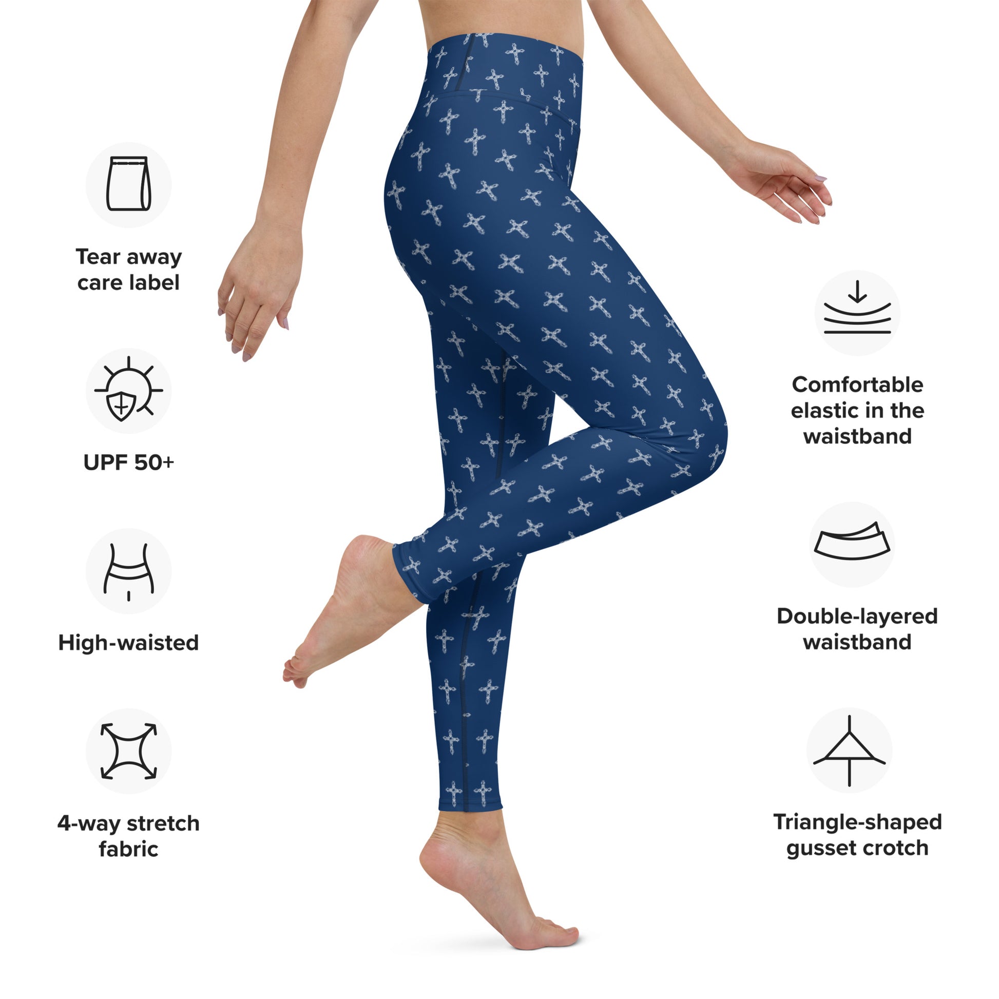 The lower half of a woman's body wearing a pair of navy stretch exercise pants with an all-over white cross print, and notes about the product around the image with symbols, including symbols and words that say:  Tear aware care label, UPF 50+, High-waisted, 4-way stretch fabric, Comfortable elastic in the waistband, double-layered waistband, and triangle-shaped gusset crotch.