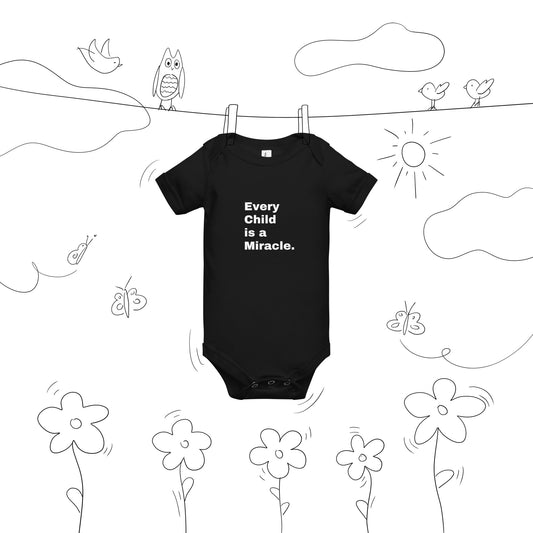 Baby's black onesie has short sleeves and white words on the front that say Every Child is a Miracle and the onesie is on a background with doodles so that it looks like it is hanging on a clothesline with clothespins and there are flowers, butterflies, birds, and clouds around it as doodles.