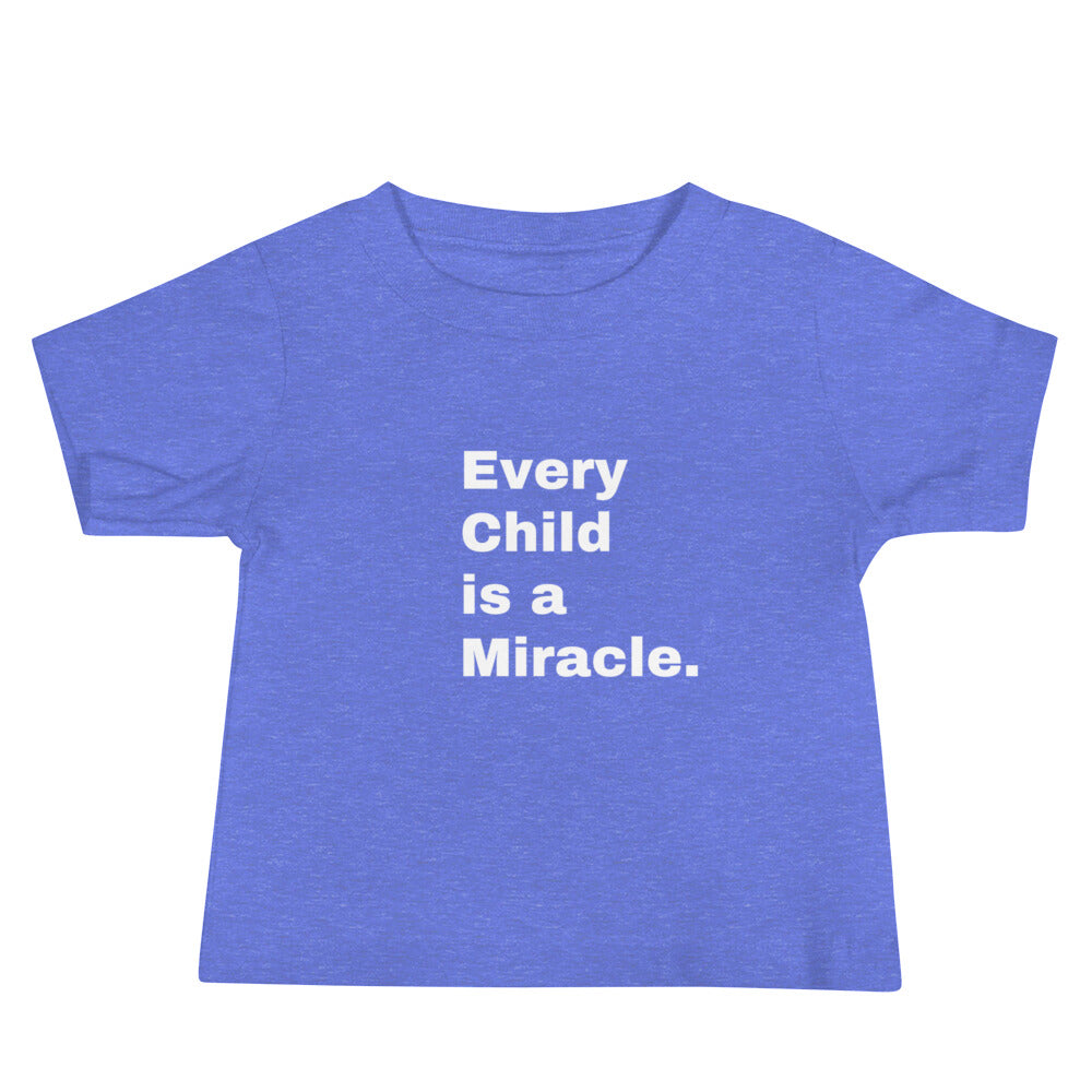 Blue short-sleeved t-shirt laying flat on a white background with the words "Every Child is a Miracle" on the front in white.