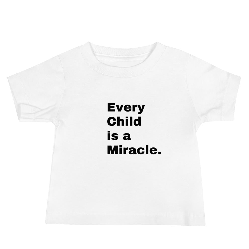 White t-shirt with short sleeves and black text that says:  Ever Child is a Miracle.