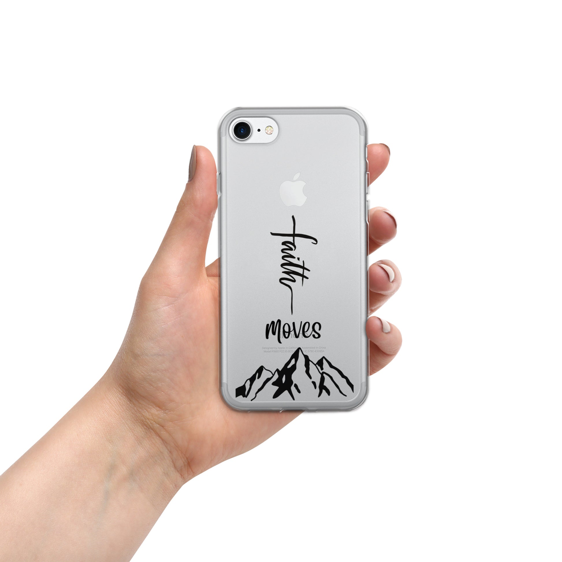 The word faith turned sideways, the word moves, and an image of mountains on a clear cell phone case on a silver iphone being held by a woman's hand on an all white background.