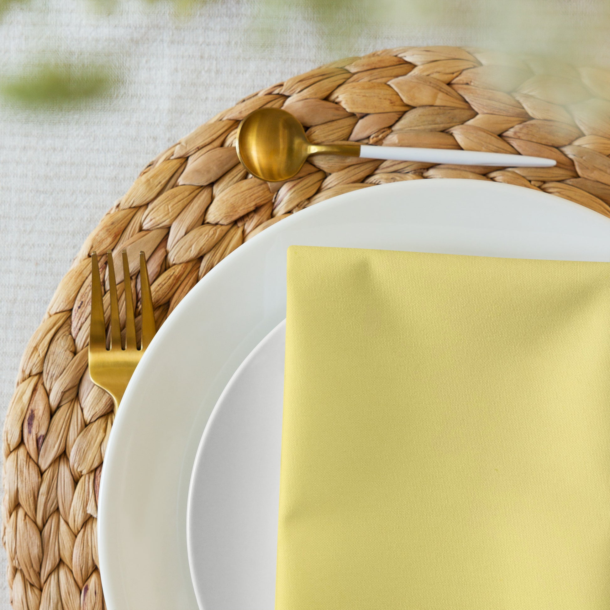 Yellow cloth napkin on dinner plates/place setting