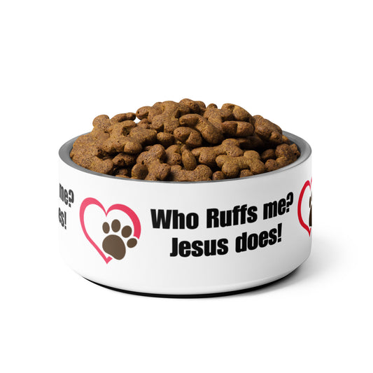 Who Ruffs me? Jesus does! are the words on the side of this white stainless steel dog bowl with a red heart graphic and a brown paw print. The dish is full of bone-shaped dog food. On a solid white background.