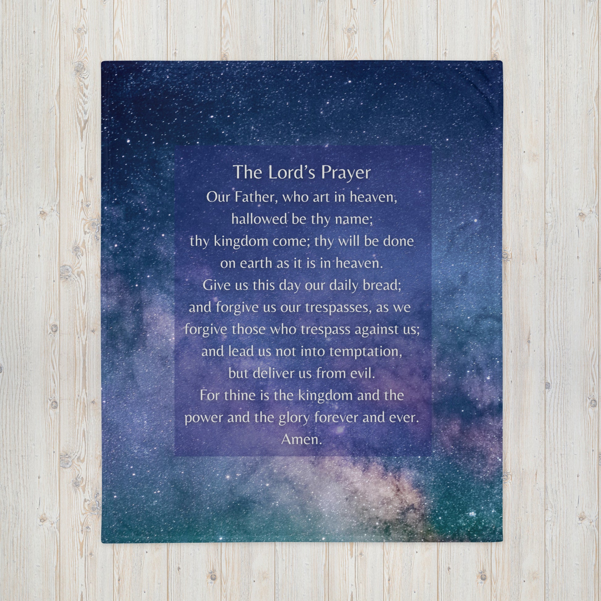 The Lord's Prayer printed on a throw blanket with a starry sky background