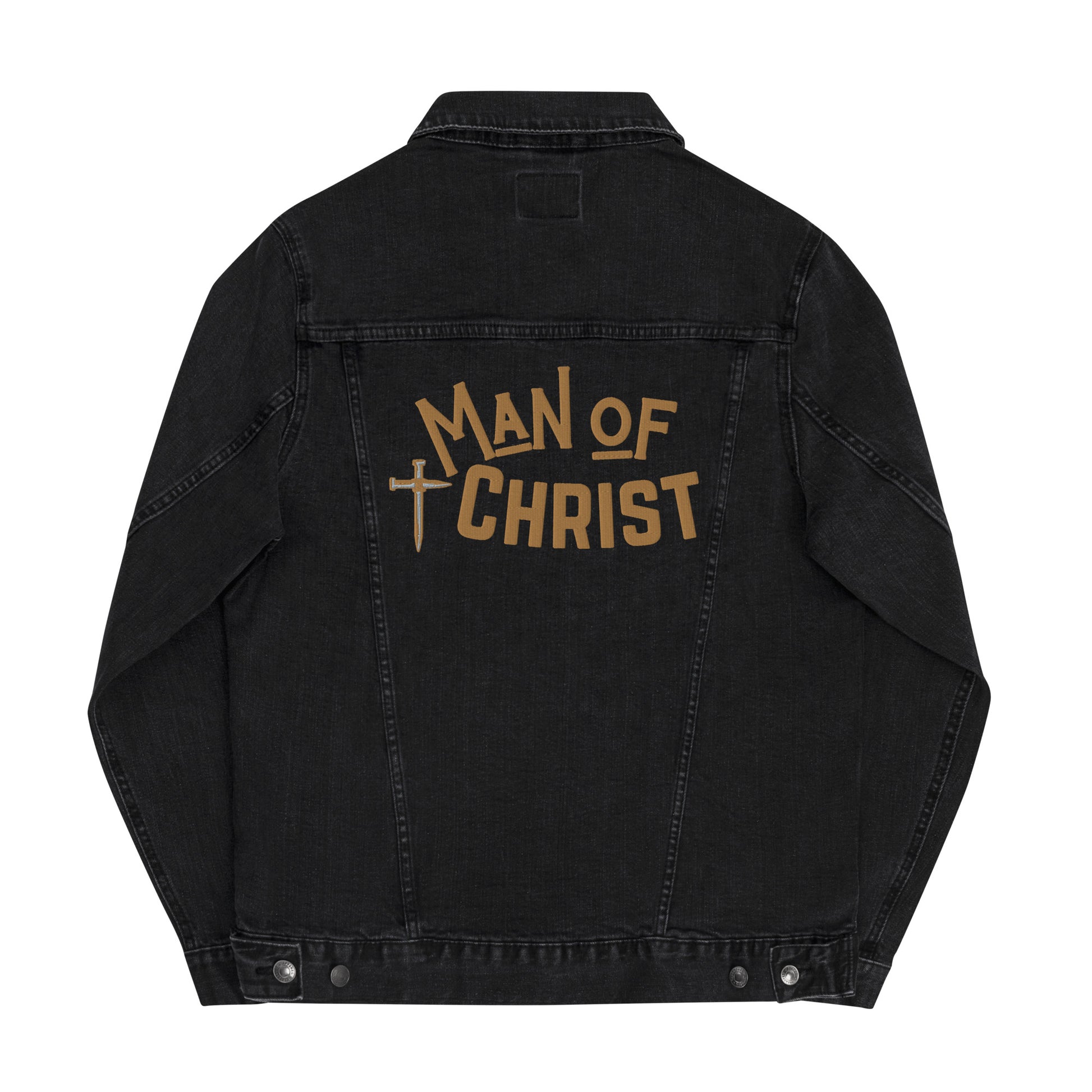 The back of a black denim jacket on a plain white background featuring the embroidered design across the back which is a cross made of nails in gold and gray and the words MAN OF CHRIST embroidered in gold lettering.