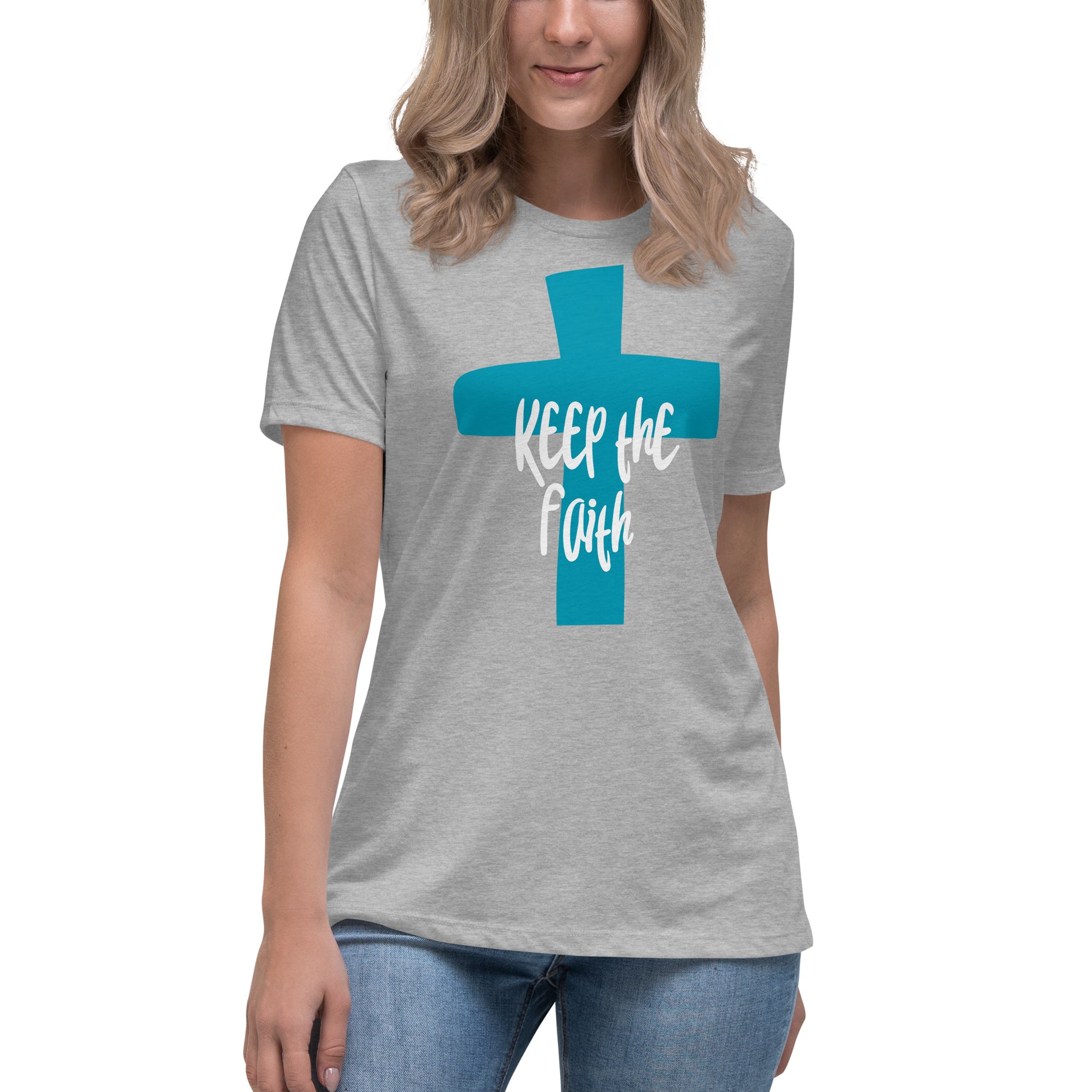 Partial view of a woman wearing a light gray short-sleeved t-shirt with a dark aqua cross on the front and the words "Keep the Faith" written in white over the top.