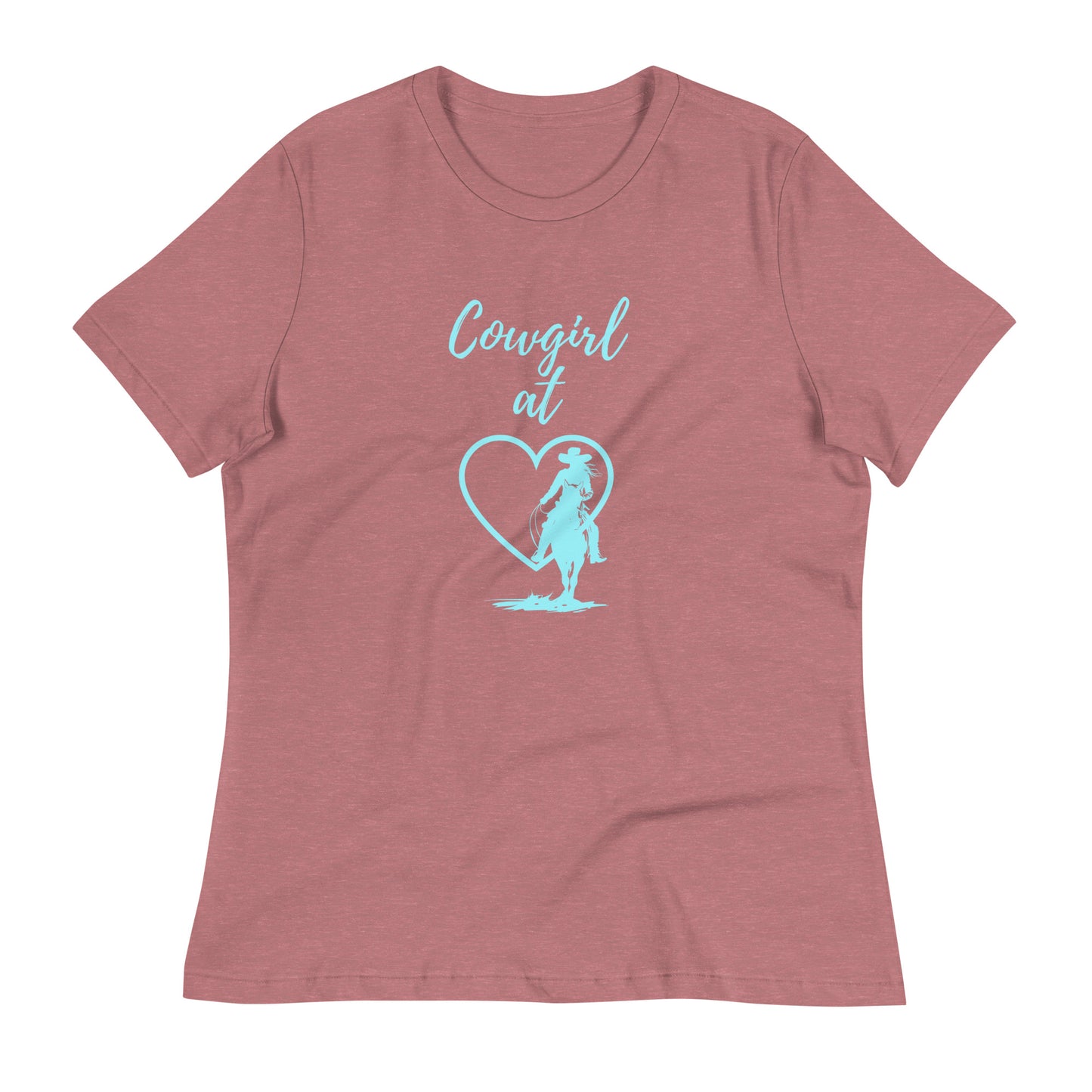 A heather mauve colored short-sleeved t-shirt with an aqua design on front. It says Cowgirl at, then a heart with a silhouette of a cowgirl on horseback in front of it.