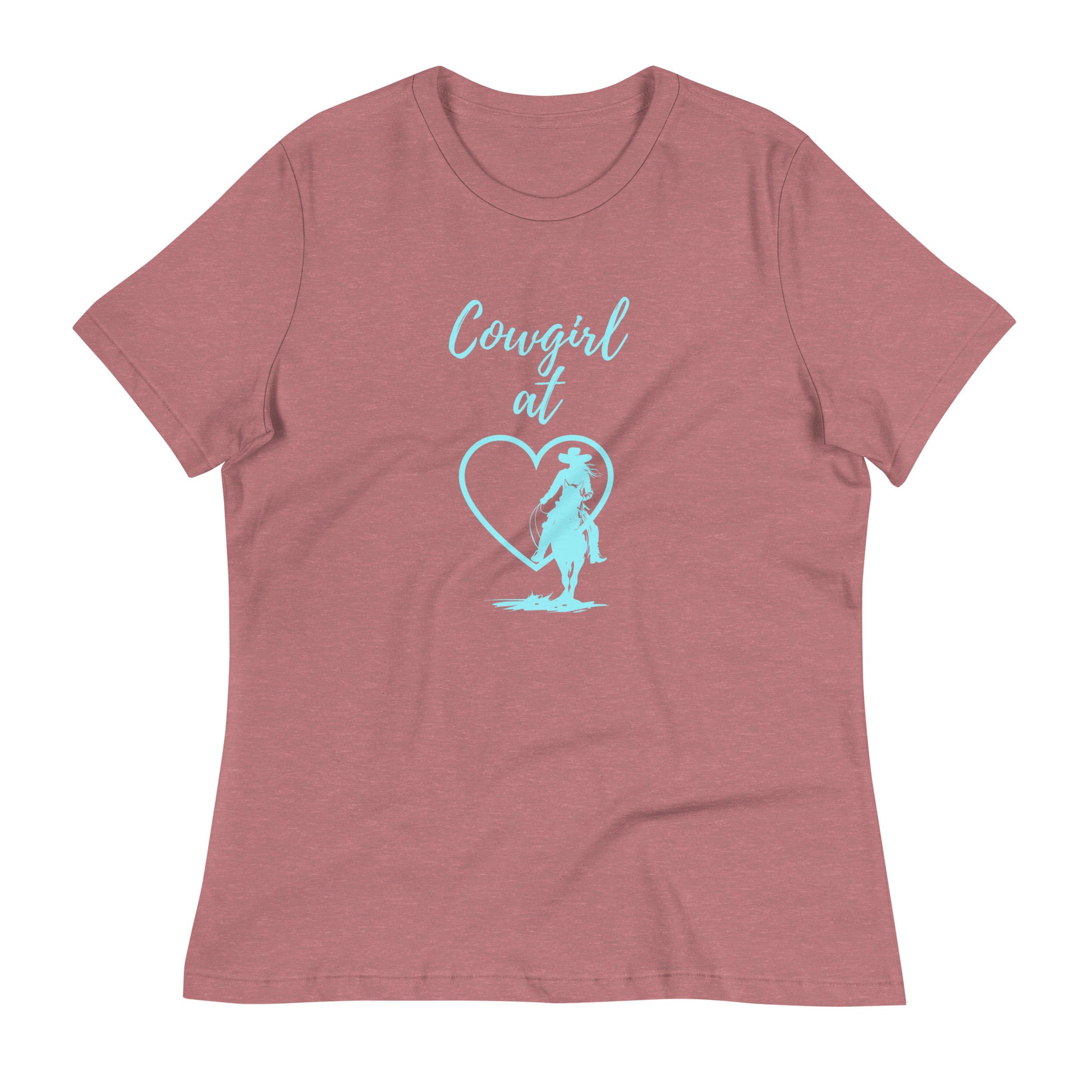 A heather mauve colored short-sleeved t-shirt with an aqua design on front. It says Cowgirl at, then a heart with a silhouette of a cowgirl on horseback in front of it.