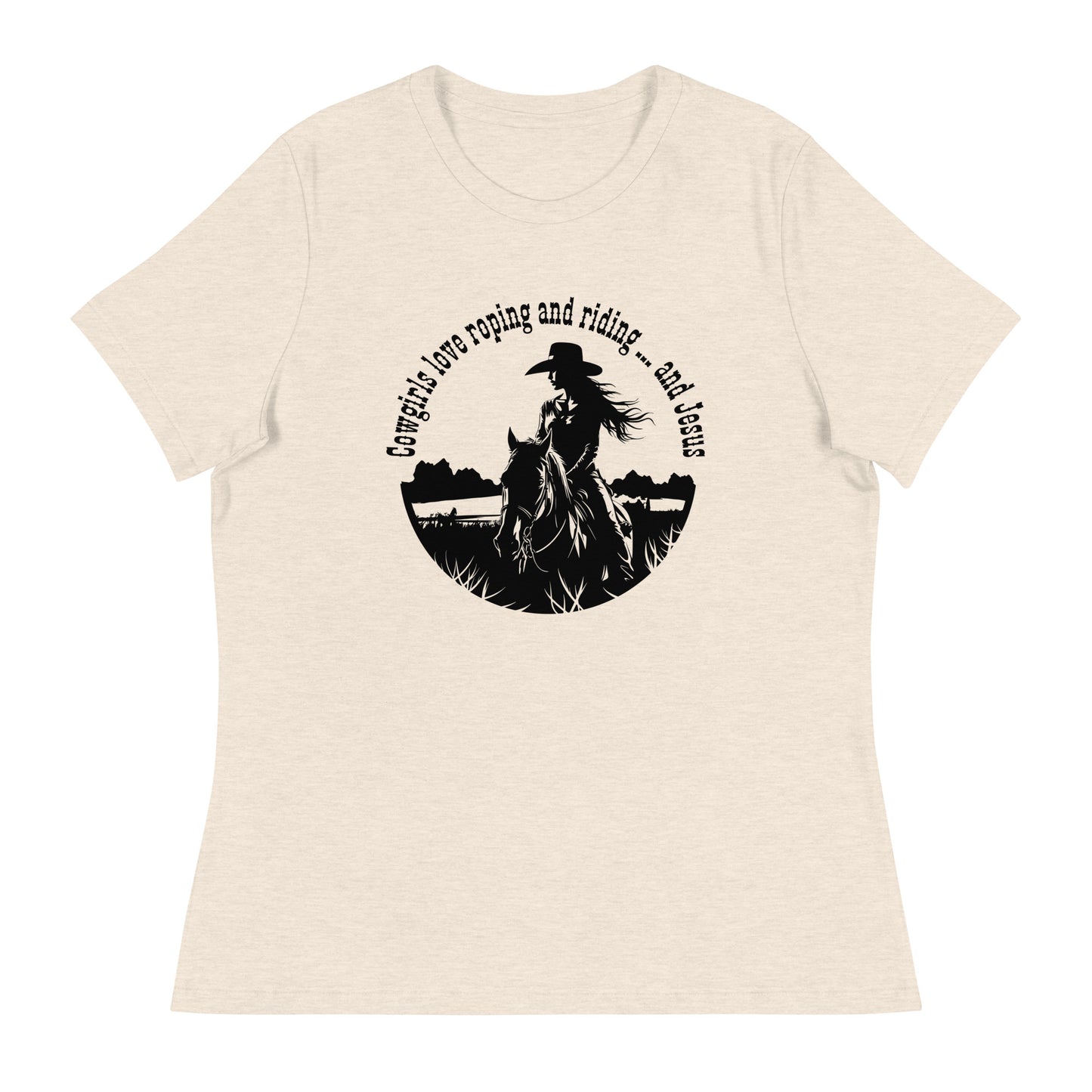 Cream t-shirt on white background with a circular image of a cowgirl on horseback with long flowing hair and a cowboy hat and the words at the top of the circle say "Cowgirls love roping and riding ... and Jesus"