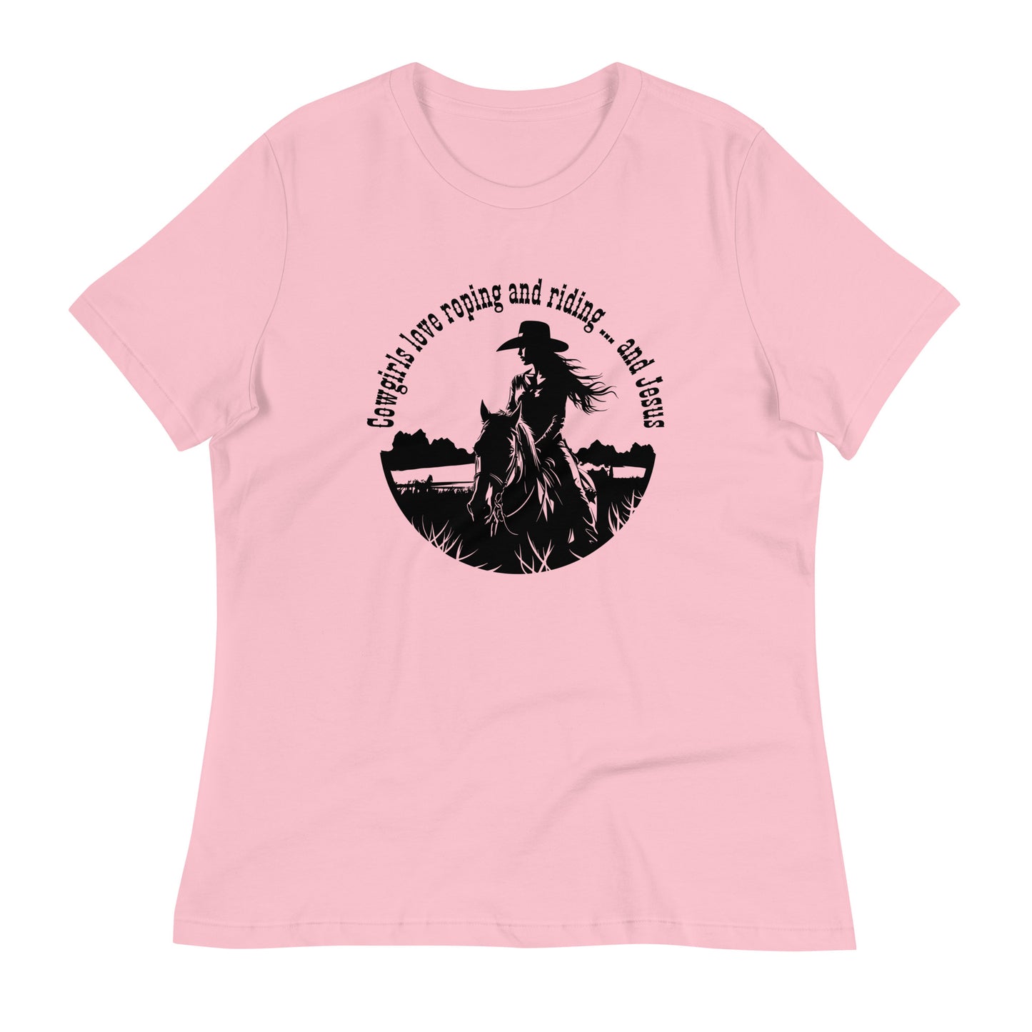 A light pink short-sleeved t-shirt with a black cowgirl design on the front features a cowgirl on horseback cropped into a circle and the words - at the top half of the circle - that say:  Cowgirls love roping and riding ... and Jesus.